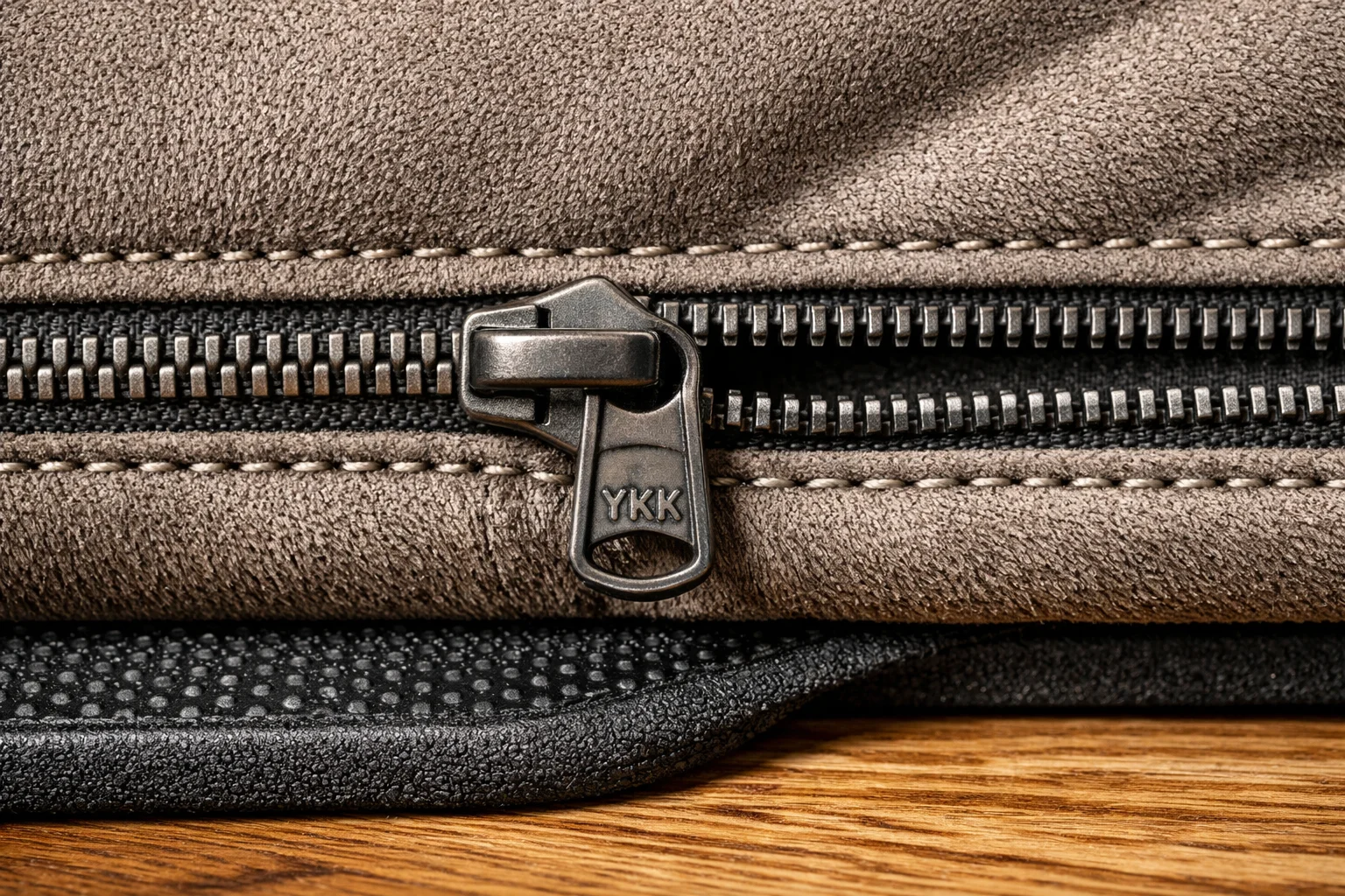 Close-up of microsuede cover with heavy-duty zipper stitching and a non-slip pad interface on hardwood